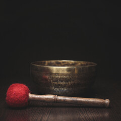 Tibetan singing bowl on dark background template