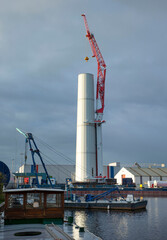 Fototapeta na wymiar Construction crane. Building a windmill. Green energy. Harbour. 