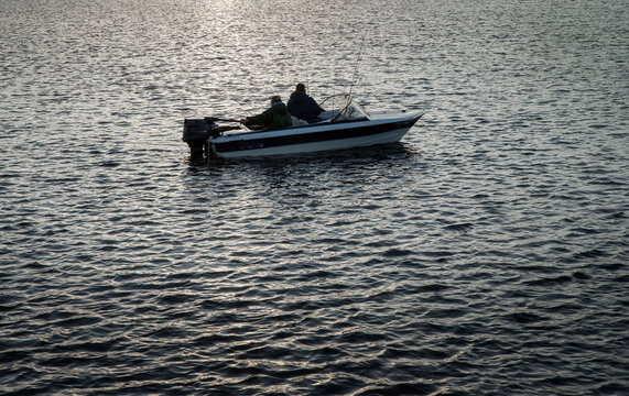 Fishing men in small motorboat. Netherlands