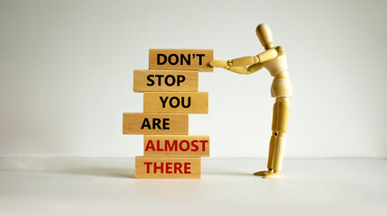 You are almost there symbol. Wooden blocks with words 'dont stop you are almost there'. Wooden...