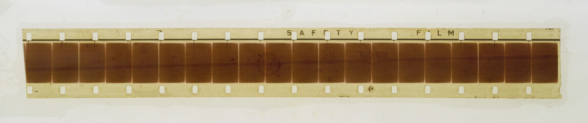 one single blank long 16mm filmstrip or snip on white fixed by transparent sticky tape foil. cool...