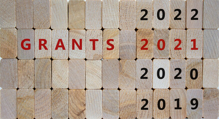 2021 grants symbol. Wooden blocks with words 'Grants 2021' and numbers 2019, 2020, 2022. Beautiful wooden background, copy space. Business and grants 2021 new year concept.