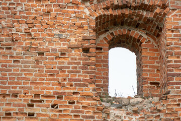 Fototapeta na wymiar Destroyed building. Red brick castle built in the last century. Historical value. Restoration and restoration of cultural property.