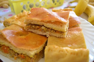 Closeup of a plate with several pieces of traditional Galician empanada