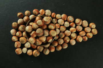 Hazelnuts on wooden backdrop. heap or stack of hazelnuts. healty food