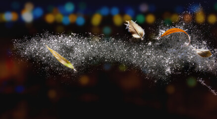 Snow and dry leaves on dark ice. Dark background with blurred lights of the night city. Snow...