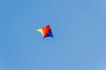 Racing kite against blue sky