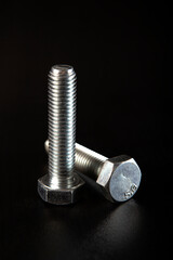 a pair of bolts on a black background