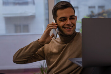 man with computer and mobile phone at home