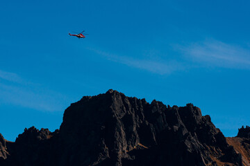 Fototapeta na wymiar helicopter over the mountains