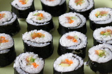 Fresh delicious Japanese sushi with avocado, cucumber and salmon