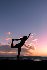 Fototapeta na wymiar Woman Practicing Yoga at Sunset on a Maui Beach