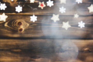 Photo out of focus. Background. Brown wooden Christmas background with stars. Christmas mood