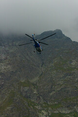 Naklejka na ściany i meble helicopter in the mountain