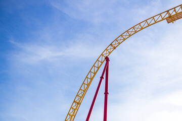 summer blurred photo of Rollercoaster against blue sky