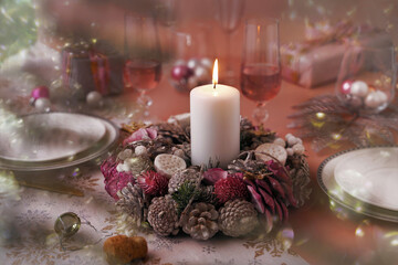 Obraz na płótnie Canvas Christmas wreath with burning candle on a table served for holiday dinner