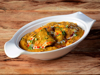 kadai paneer is a famous indian dish, served over a rustic wooden background, selective focus