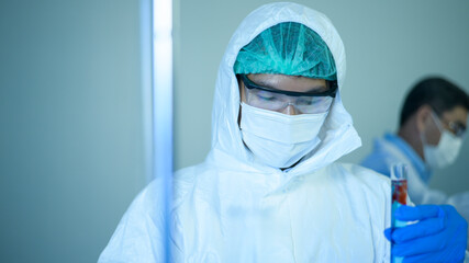 Fototapeta na wymiar Scientist holding liquid chemical tube in laboratory, Science and technology healthcare concept