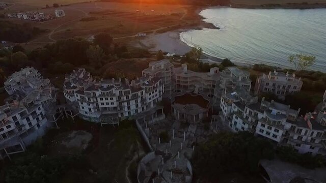 Aerial view during the sunset through the empty buildings of the abandoned hotel Costa del Croco, located near the seaside town of Tsarevo.