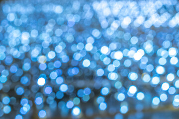 Blue bokeh lights. Abstract glitter festive blur background. Christmas and New Year holidays backdrop.