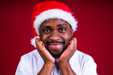 brazilian man wear santa claus headwear isolated over red color background