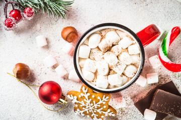 Christmas drink. Hot chocolate with marshmallow and holiday decorations at white table. Top view image.