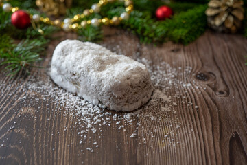 Traditional Christmas Shtollen Cake on a wood background. Selective focus