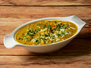 Paneer banjara, is a famous indian dish, served over a rustic wooden background, selective focus