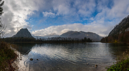 beautiful lake in the mountains with clouds on the sky panorama