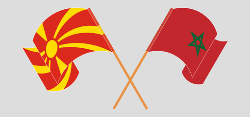 Crossed and waving flags of North Macedonia and Morocco