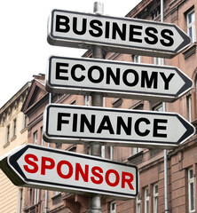 The road indicator on the arrows of which is written - business, economics, finance and SPONSOR