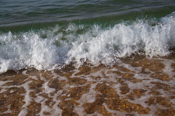 Sea waves hitting the sand