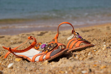 Sandals stand on the sea sand