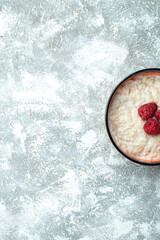 Obraz na płótnie Canvas top view delicious porridge with raspberries on light background oatmeal breakfast morning sweet photo free space