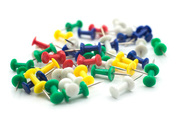 Closeup of colorful paper pins on white background