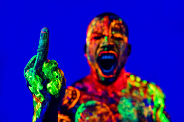 afro american man with UV body art posing in studio