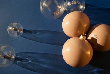 Decoration beige and transparent balls decoration on dark blue background with long shadows. New...