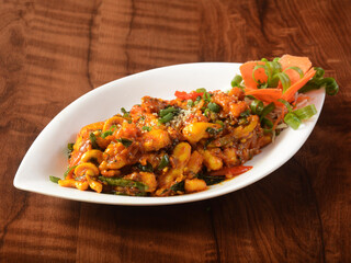 Paneer majestic, is a famous indian dish, served over a rustic wooden background, selective focus