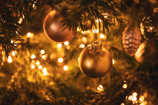 golden ball ball on a decorated Christmas tree with festive lights
