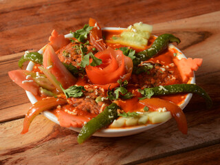 Paneer maharaja, is a famous indian dish, served over a rustic wooden background, selective focus