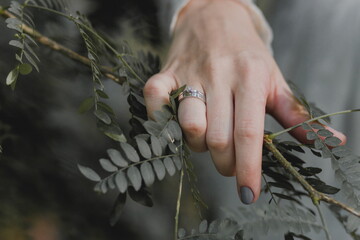 Beautiful white gold rings with a diamond on the ring finger close-up. .