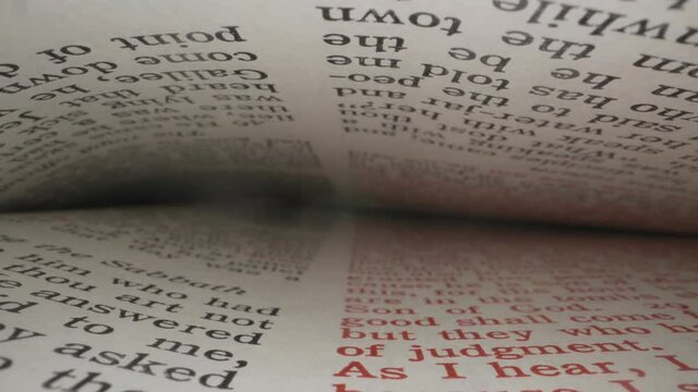 Macro close up view of the inside of a bible sliding along the pages