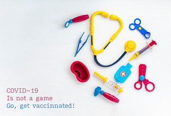 Children's medical instruments. Children's doctor concept. Pediatrics. Toy medical devices on a white background. Covid-19 is not a game. Go, get vaccinated Concept. High quality photo