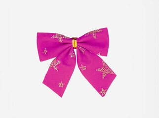 Pink purple ribbon bow with gold star pattern for gift to Christmas day close up view isolated on a white background