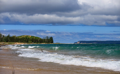 The shoreline of Lake Michigan, Blue skies, turquoise water, and clouds approaching