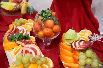 Fototapeta na wymiar Top view of a decorated banquet table with various fruits for a corporate birthday or wedding celebration.