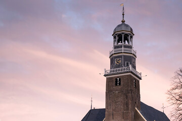 Tower of the reformed Church in the center of the village Lemmer at sunset in Friesland, The...