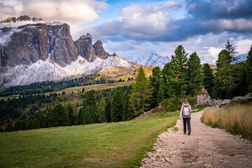 female hiker on trekking path with view on sellaronda mountains