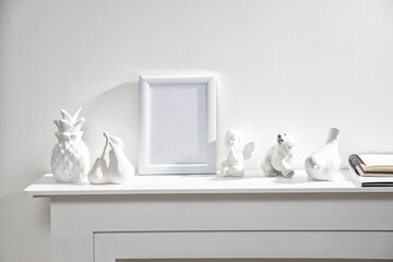 Figurines of a polar bear, pineapple, pears, an angel, a bullfinch bird and a white photo frame...