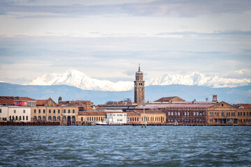Murano Island with snow capped Alpes in background - obrazy, fototapety, plakaty